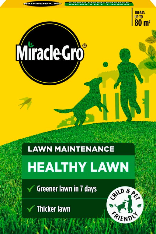Miracle-Gro lawn maintenance product packaging with a child and dog silhouette on a grassy background.