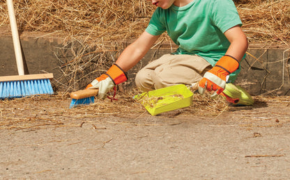 Person cleaning up with tools on a concrete surface