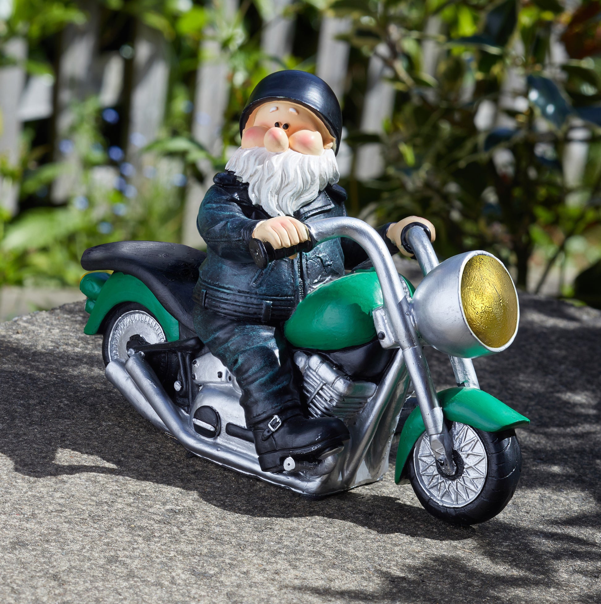 Gnome figurine riding a motorcycle with a green and black color scheme.