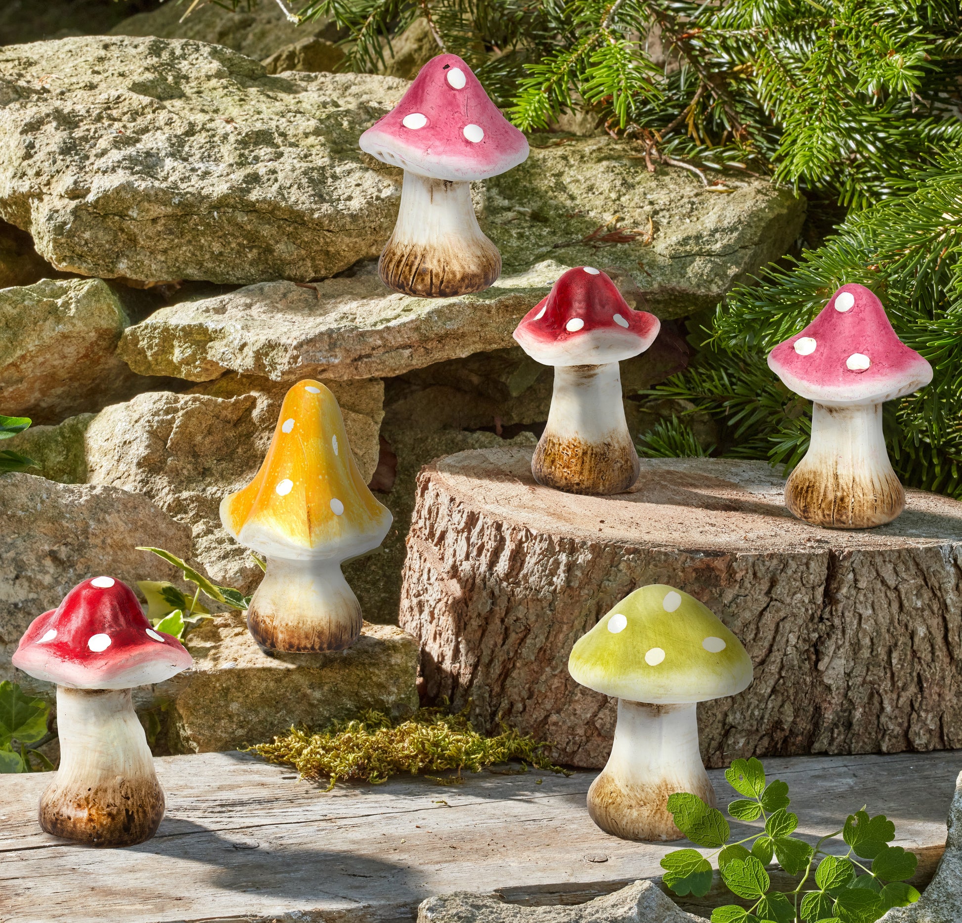Colorful mushroom figurines on a natural stone and wood background