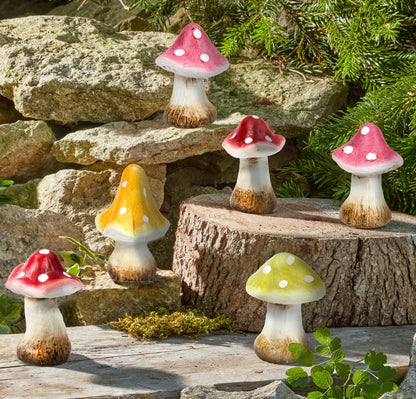 Colorful mushroom figurines on a natural stone and wood background