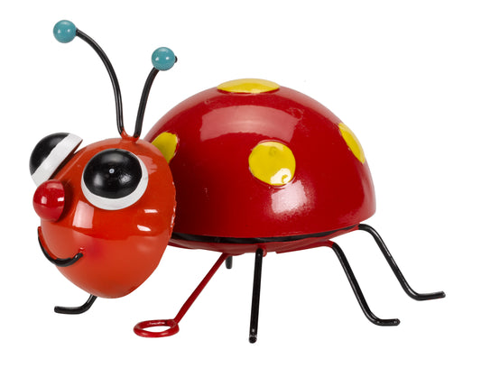 Toy ladybug with a red body, black legs, and yellow spots on a white background