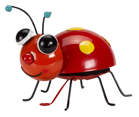 Toy ladybug with a red body, black legs, and yellow spot on a white background