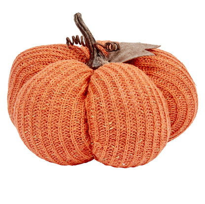 Knitted pumpkin decoration on a white background