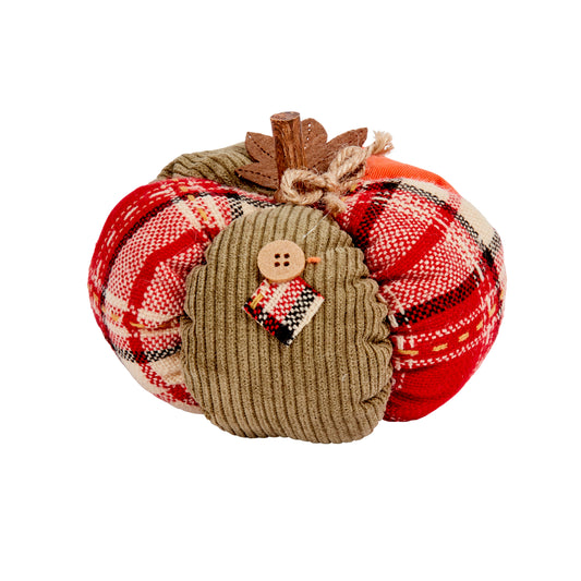 Decorative pumpkin with plaid patterns and a small figurine on a white background
