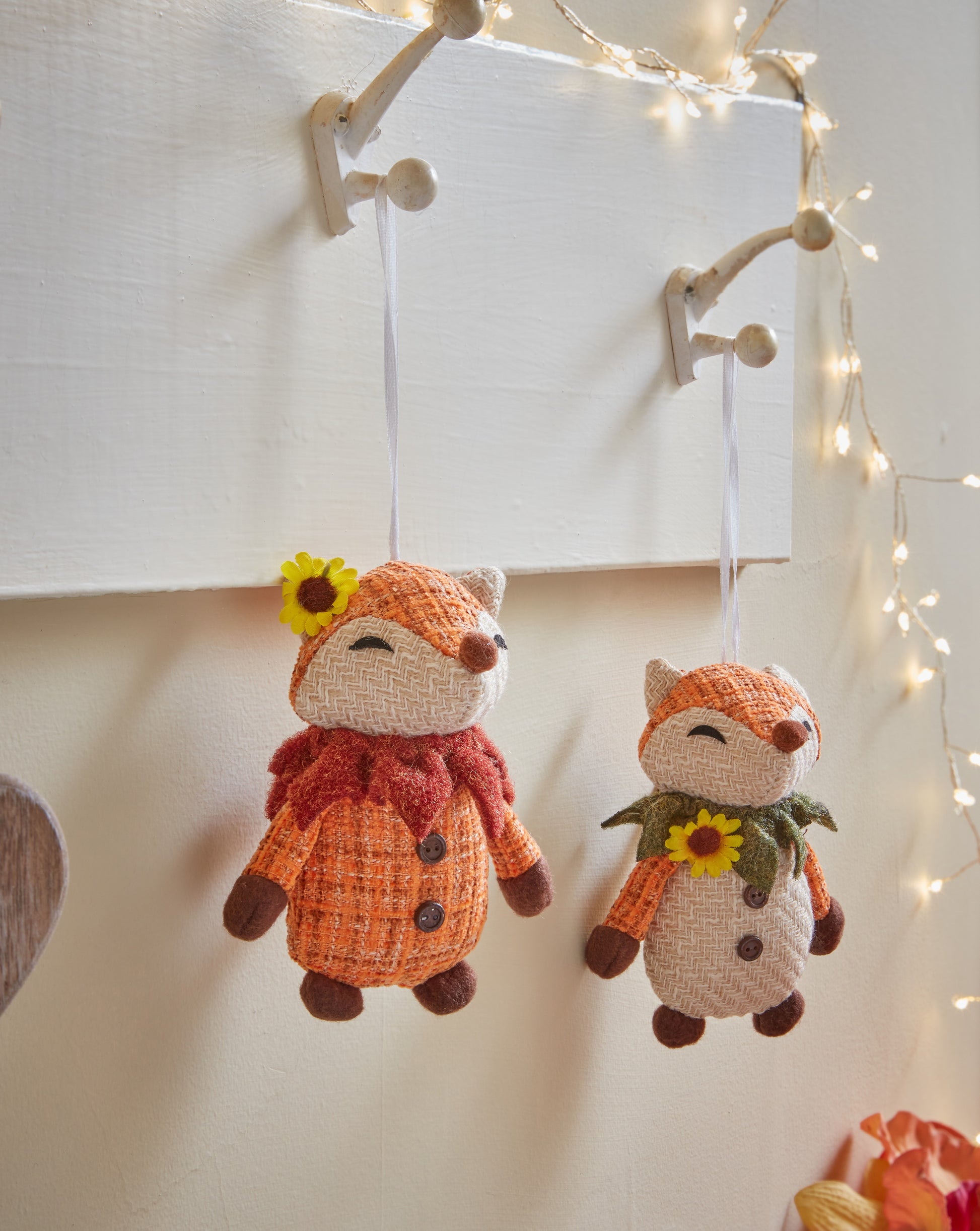 Knitted foxes hanging on hooks