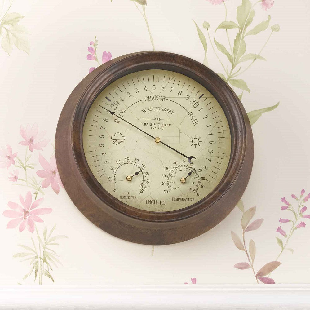 Round wooden weather station with a floral background