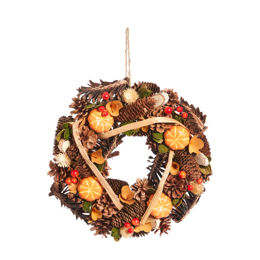 Decorative wreath with pinecones, oranges, and berries on a white background