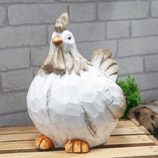 Decorative chicken figurine on a wooden surface with a brick wall background