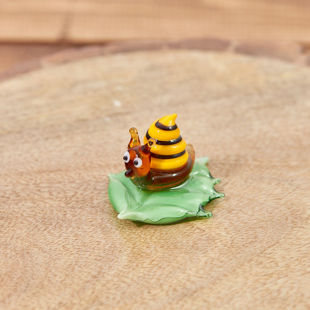 Hand-blown glass snail ornament | Yellow and brown striped shell on a green glass leaf | Decorative garden figurine UK