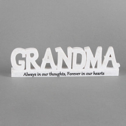 White wooden sign with 'GRANDMA' and text on a gray background