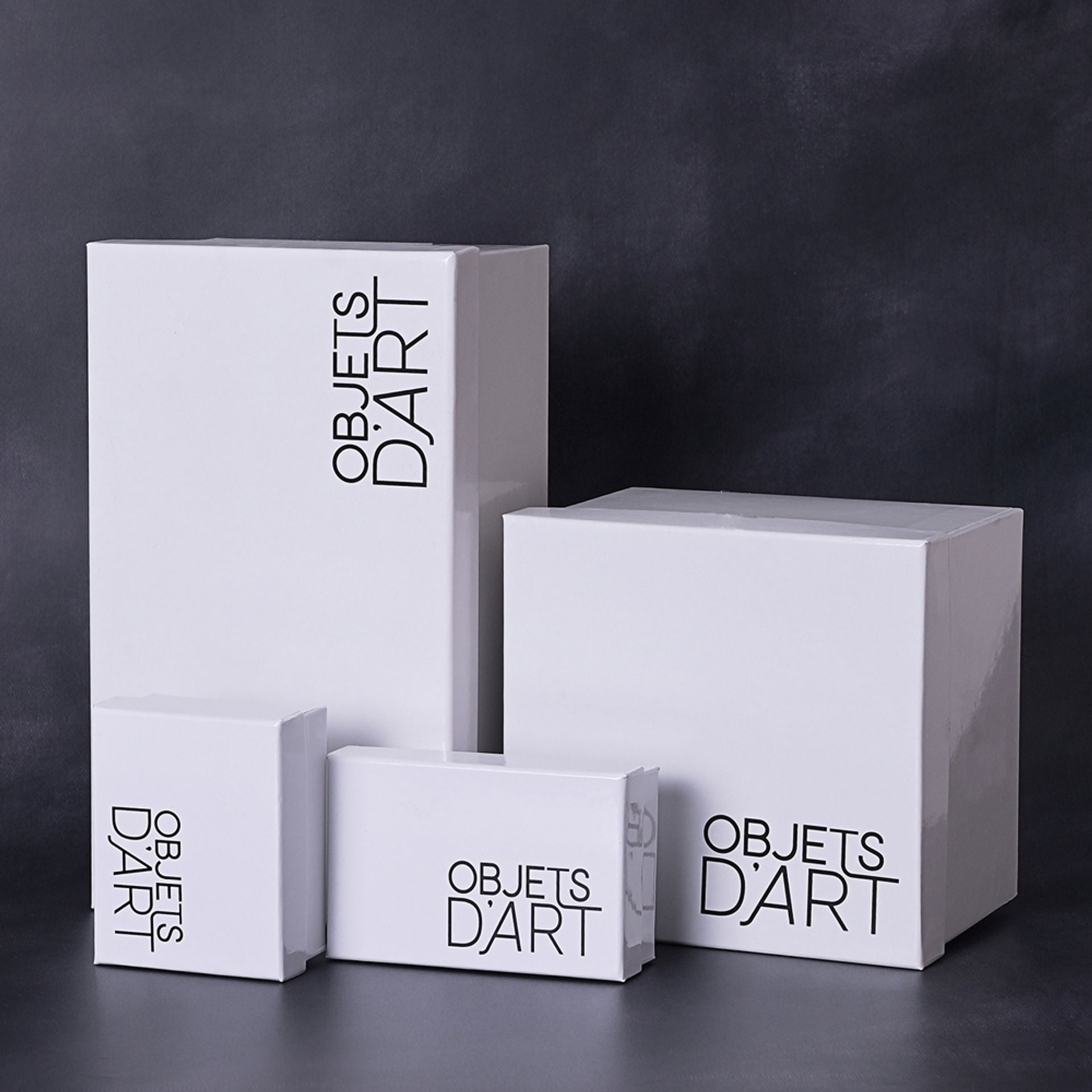 White boxes with 'Objets Dart' branding on a dark background