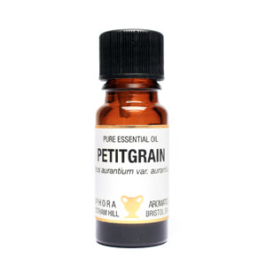 Bottle of petitgrain essential oil with a white label on a white background