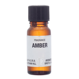 Amber fragrance oil bottle with a black cap on a white background