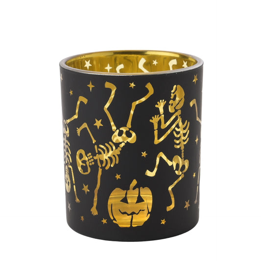 Black candle holder with gold skeletons and pumpkin design on a white background