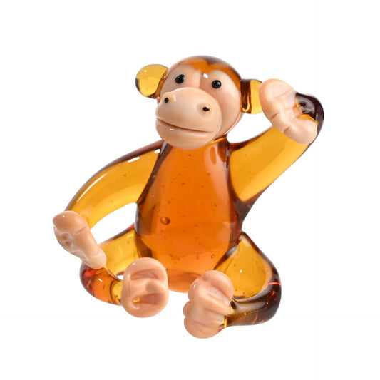 Glass monkey figurine on a white background