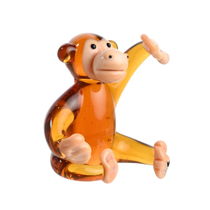 Glass monkey figurine on a white background