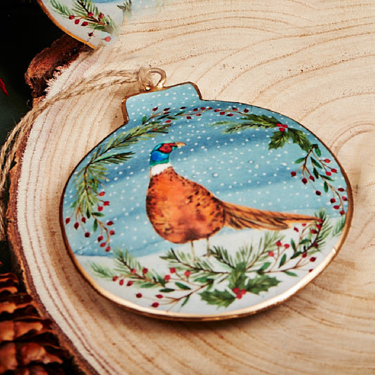 Decorative ornament with a pheasant design on a wooden surface