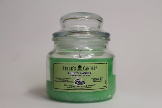 Green candle in a glass jar with 'Price's Candles' label on a white background