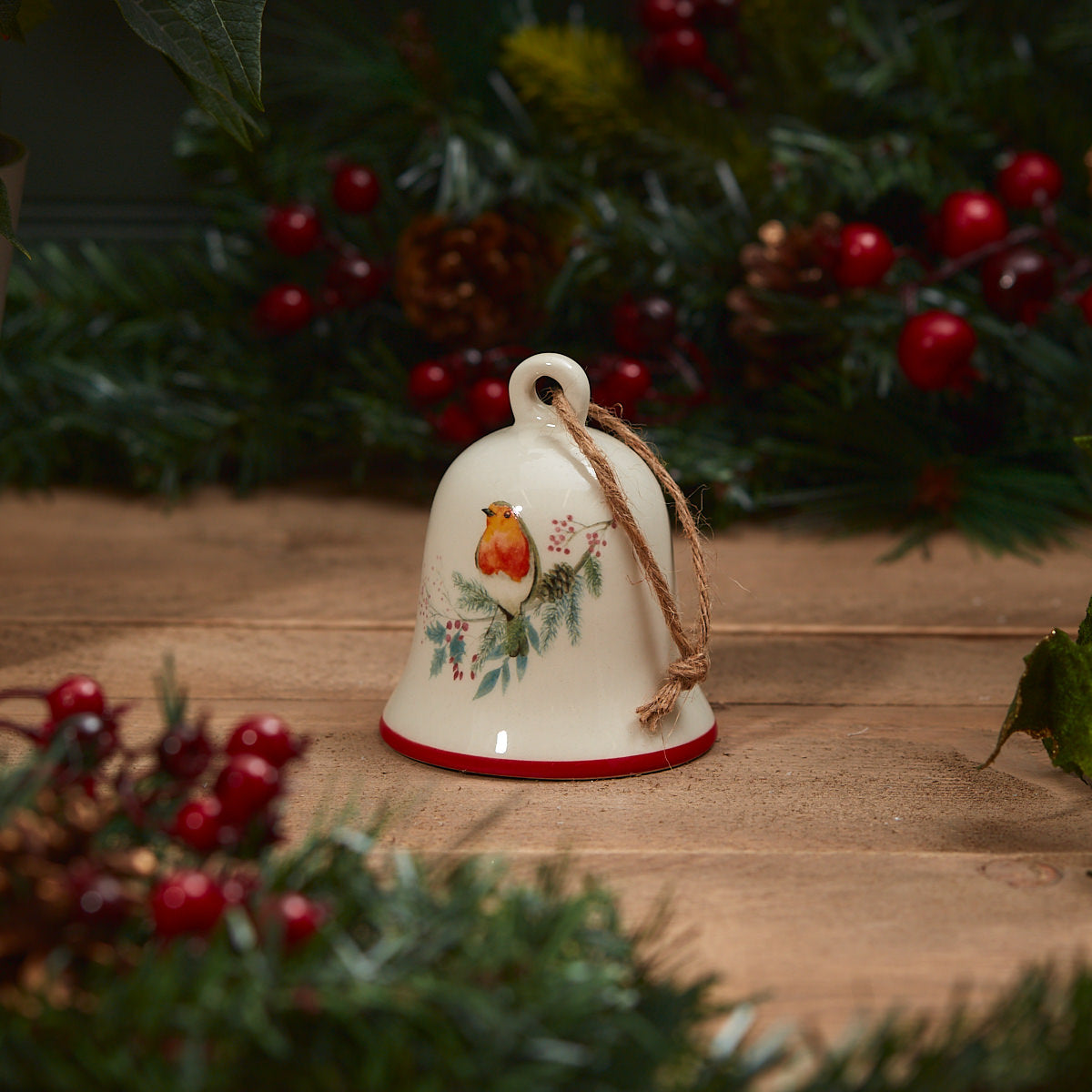 Robin decorated hanging bell on a wooden table