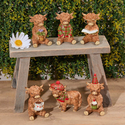 Set of six Highland Cow Sitting Figures | Resin ornaments in various poses wearing Christmas jumpers, hats, and glasses, drinking tea and reading | UK seasonal animal decorations