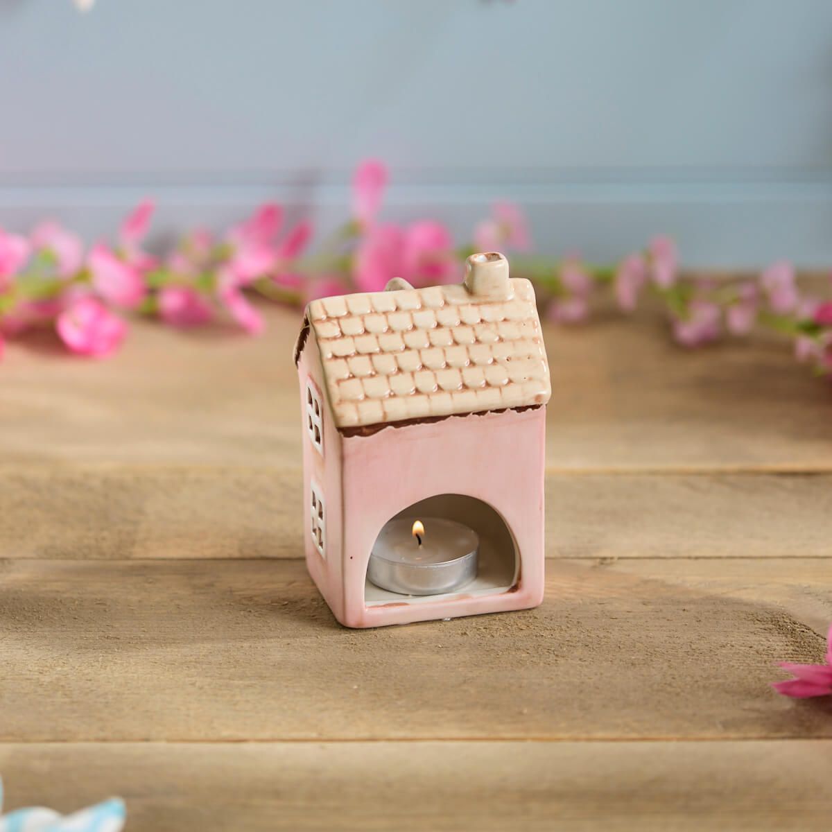 Pink ceramic miniature house ornament | Decorative cottage figurine with tan roof and floral detail in a garden setting | UK home or garden décor
