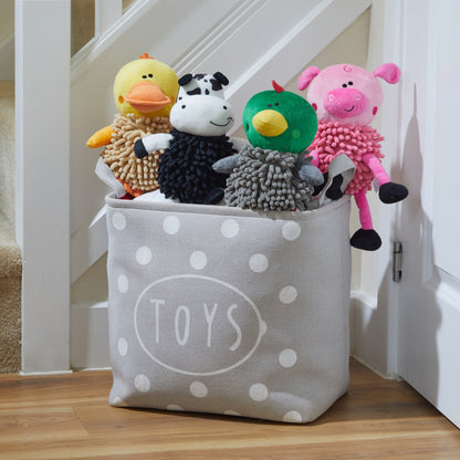 Toy storage bin with various plush toys on a wooden floor.