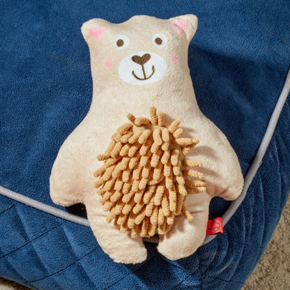 Plush toy bear with a lion's mane on a blue blanket