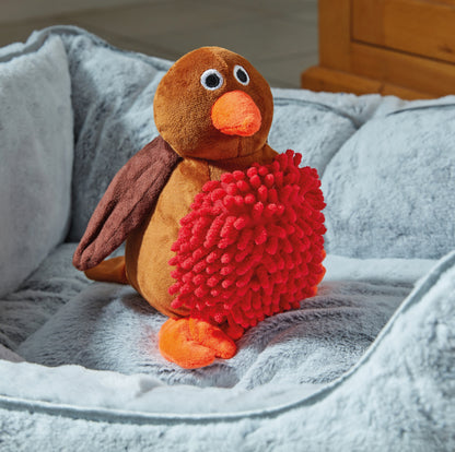 Plush toy penguin with a red textured ball on a gray blanket