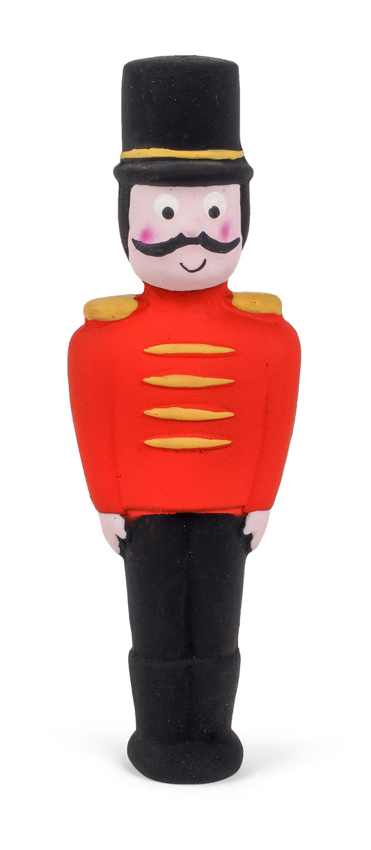 Toy figure of a soldier in a red uniform with a black top hat on a white background