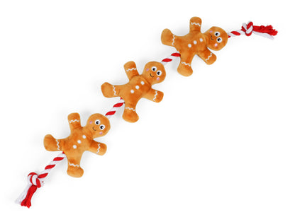 Gingerbread man dog toy with red string on a white background