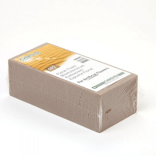 Block of floral foam with a label on a white background