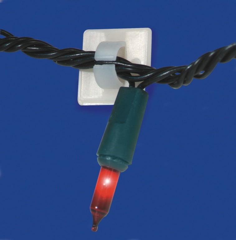 Close-up of a red Christmas light bulb on a blue background