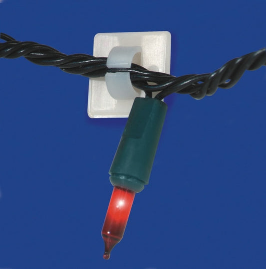 Close-up of a red Christmas light bulb on a blue background