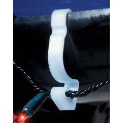 Close-up of a white cable tie on a black cable against a blue background