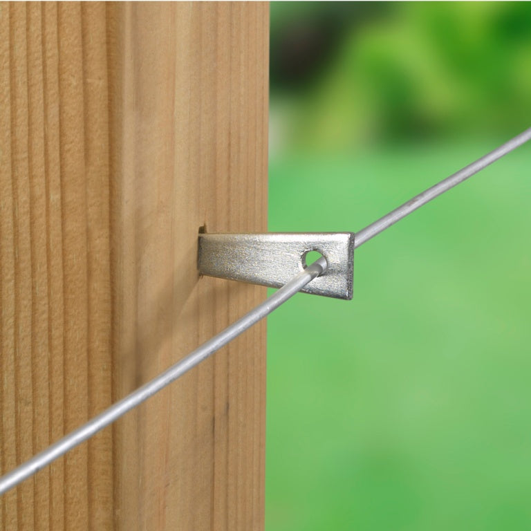 Metal bracket attached to a wooden post with a blurred green background