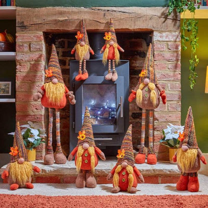 Decorative gnomes in front of a fireplace with a warm ambiance