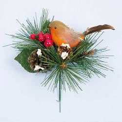 Decorative arrangement with a robin bird, pine needles, and berries on a light blue background