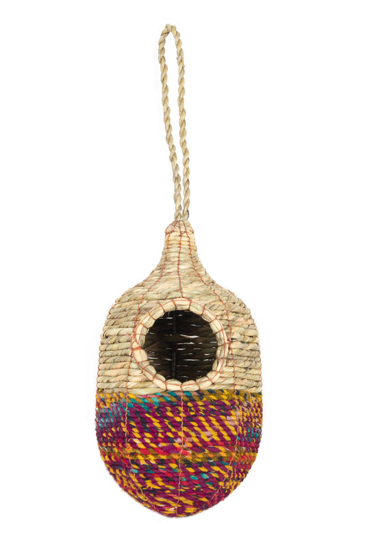 Woven birdhouse with colorful base and rope attachment on a white background