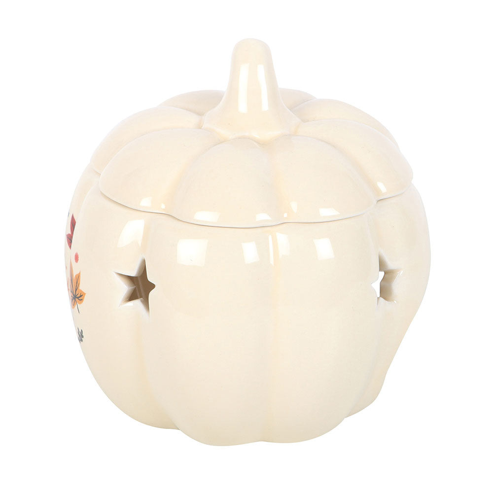 Cream-colored ceramic pumpkin with star designs on a white background