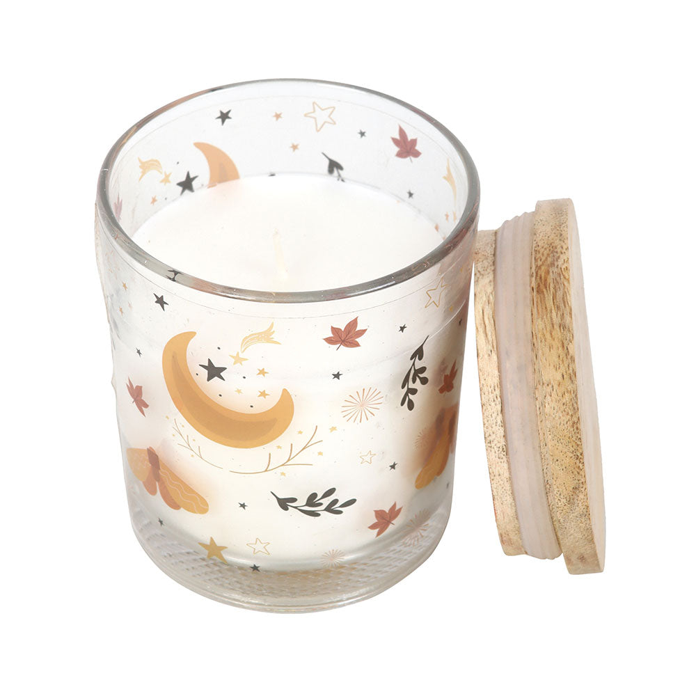 Glass jar with moon and star design and wooden lid on a white background
