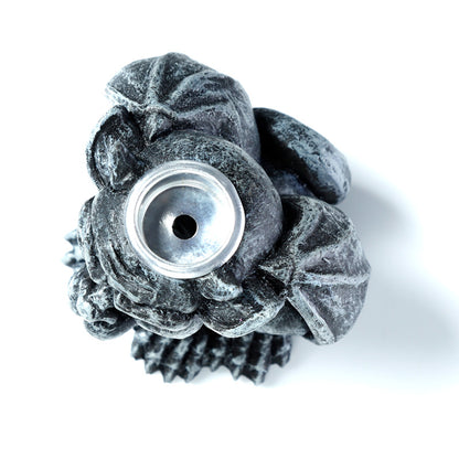 Gargoyle shaped incense burner on a white background
