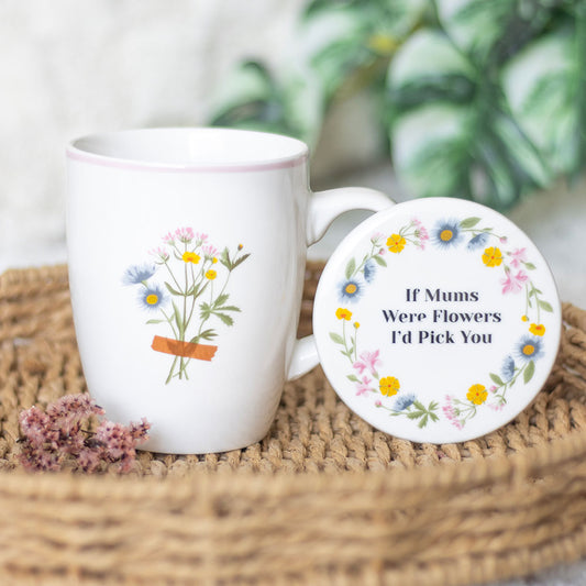 White mug with floral design and matching coaster on a woven surface