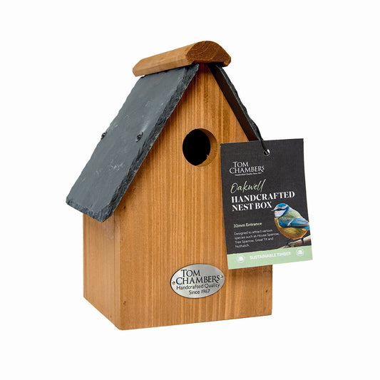 Wooden birdhouse with a slate roof and Tom Chambers branding on a white background
