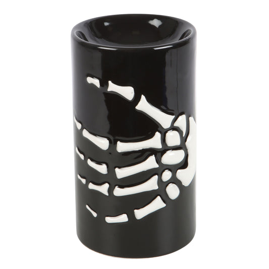 Black ceramic oil burner with white skeleton design on a white background