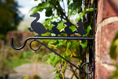 Decorative metal wall hook with duck design on a brick wall