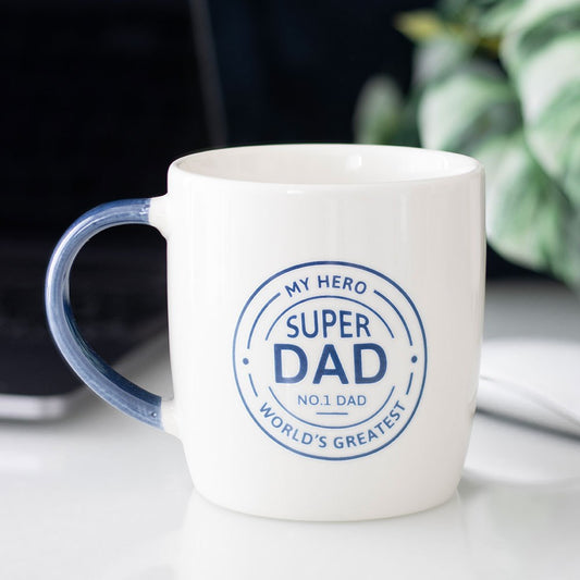 White mug with blue text 'Super Dad' on a light surface