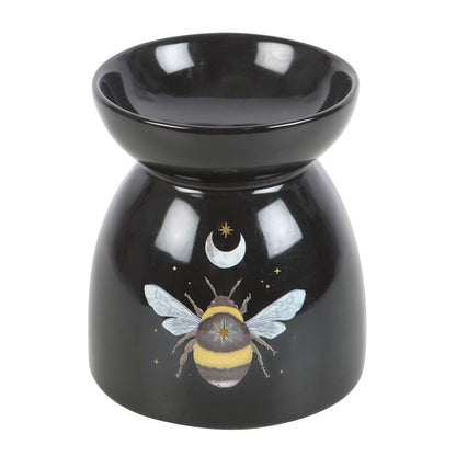 Black ceramic oil burner with bee design on a white background