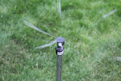 Sprinkler spraying water on a grassy area