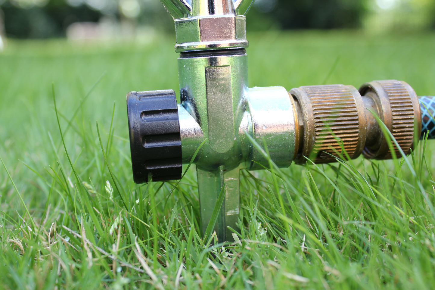 Close-up of a garden sprinkler head on grass